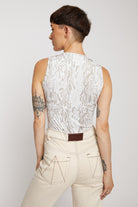 Upper back view of the model wearing the ecru wash jeans