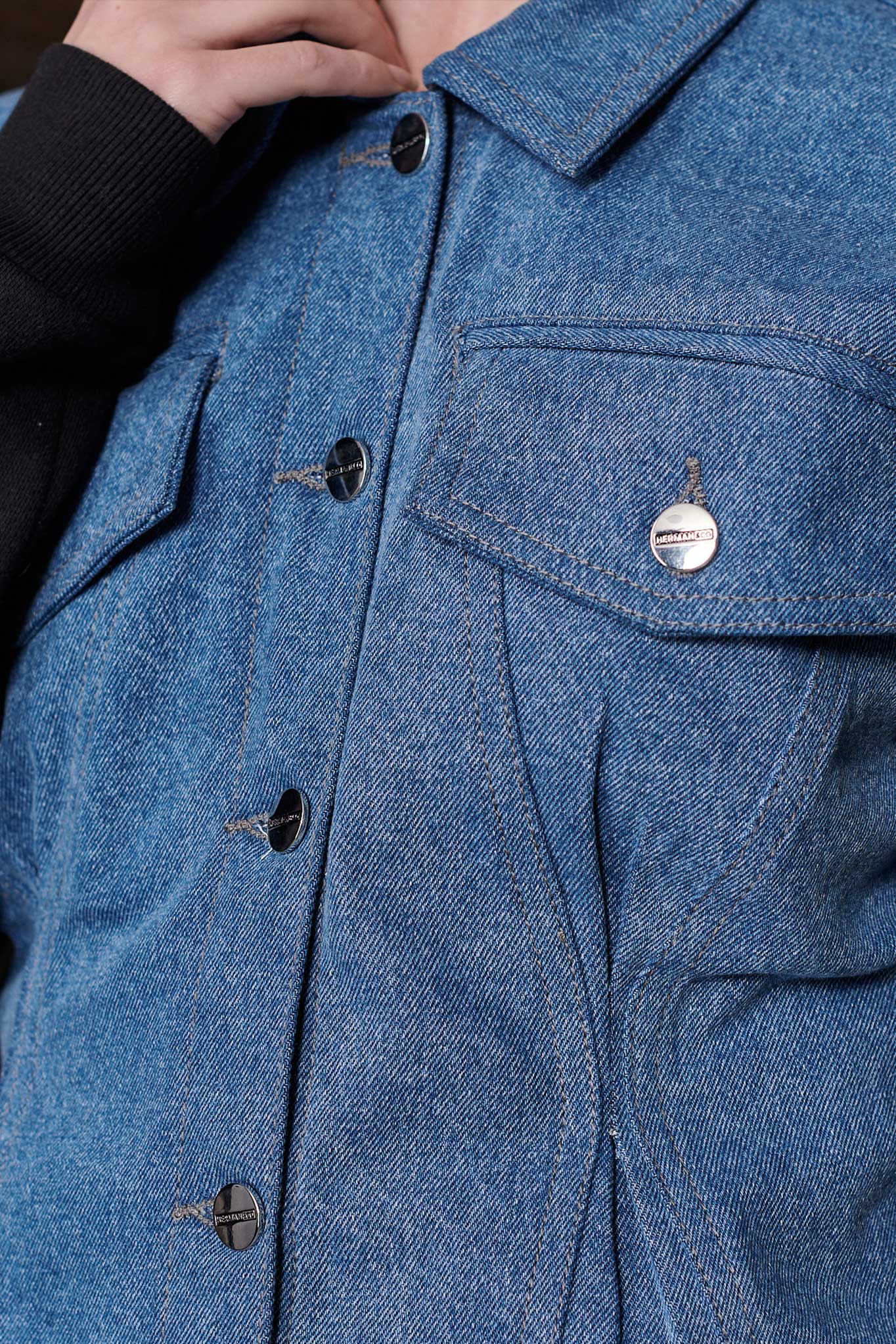 Close-up of the collar and button details on the women's fleece jean jacket.