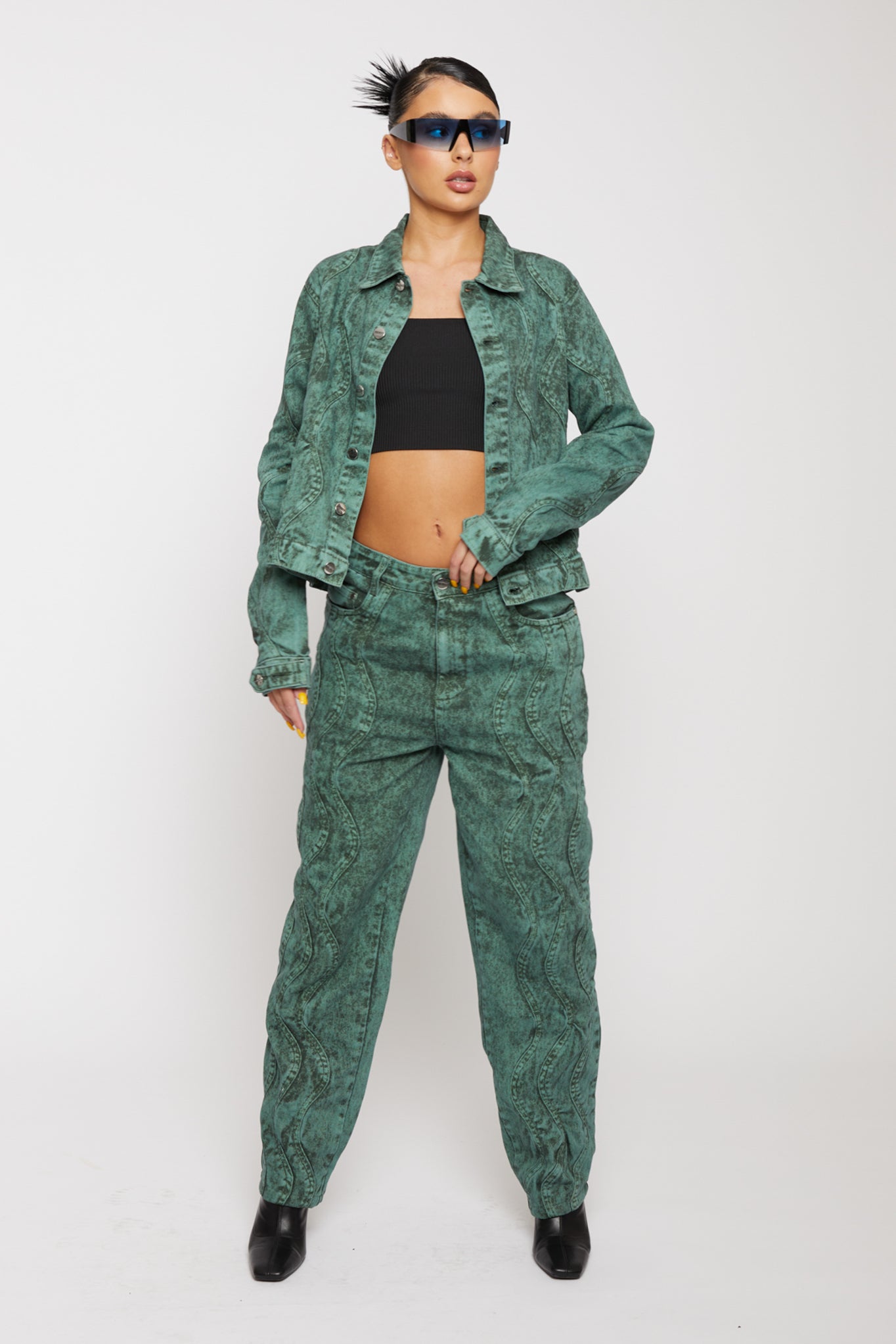Model wearing the high-waisted green acid wash jeans with a matching jacket.