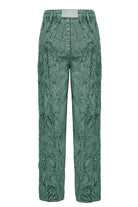 Back view of the green acid wash tapered baggy jeans laid flat.