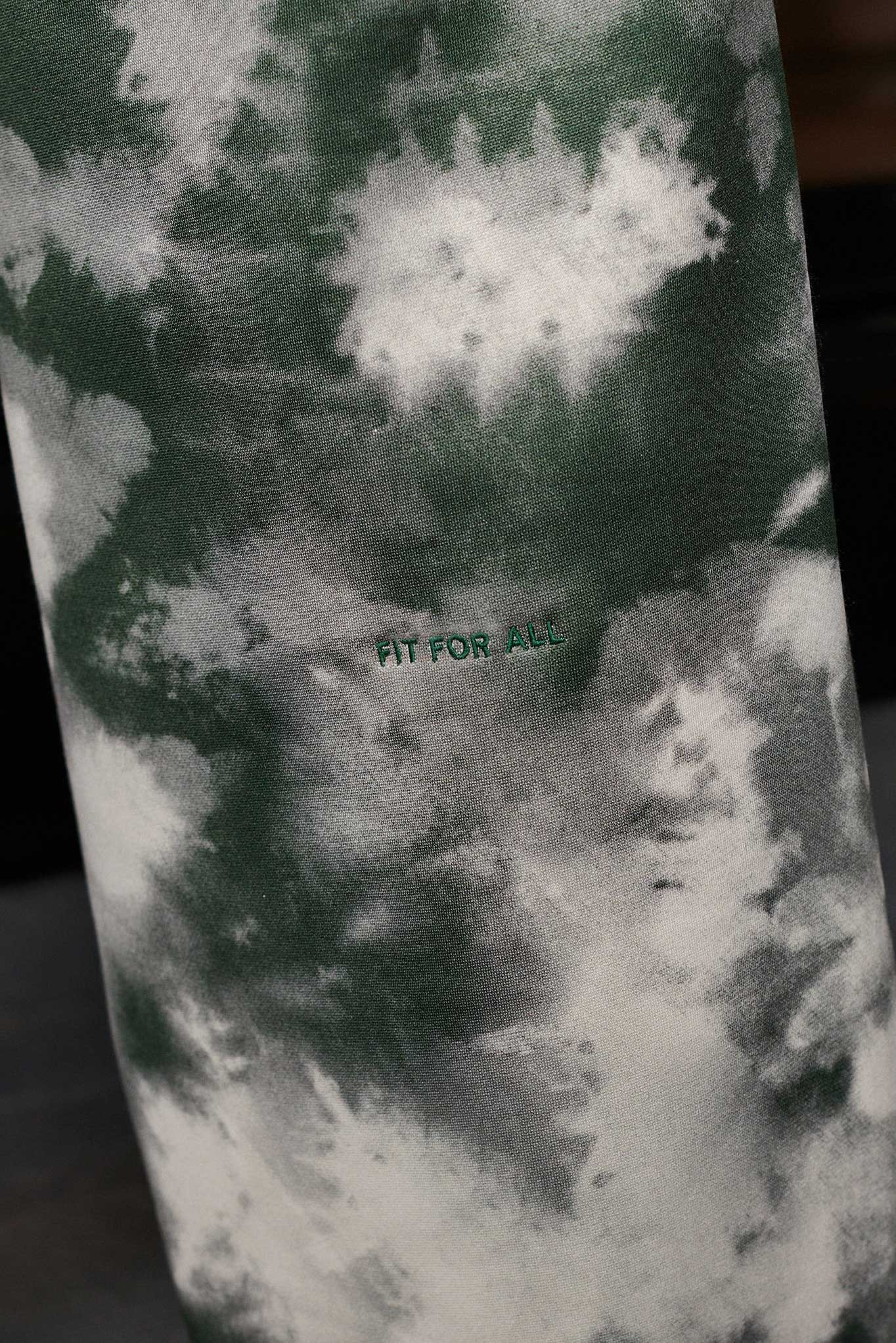 Close-up of the green and white tie-dye pattern on the joggers.