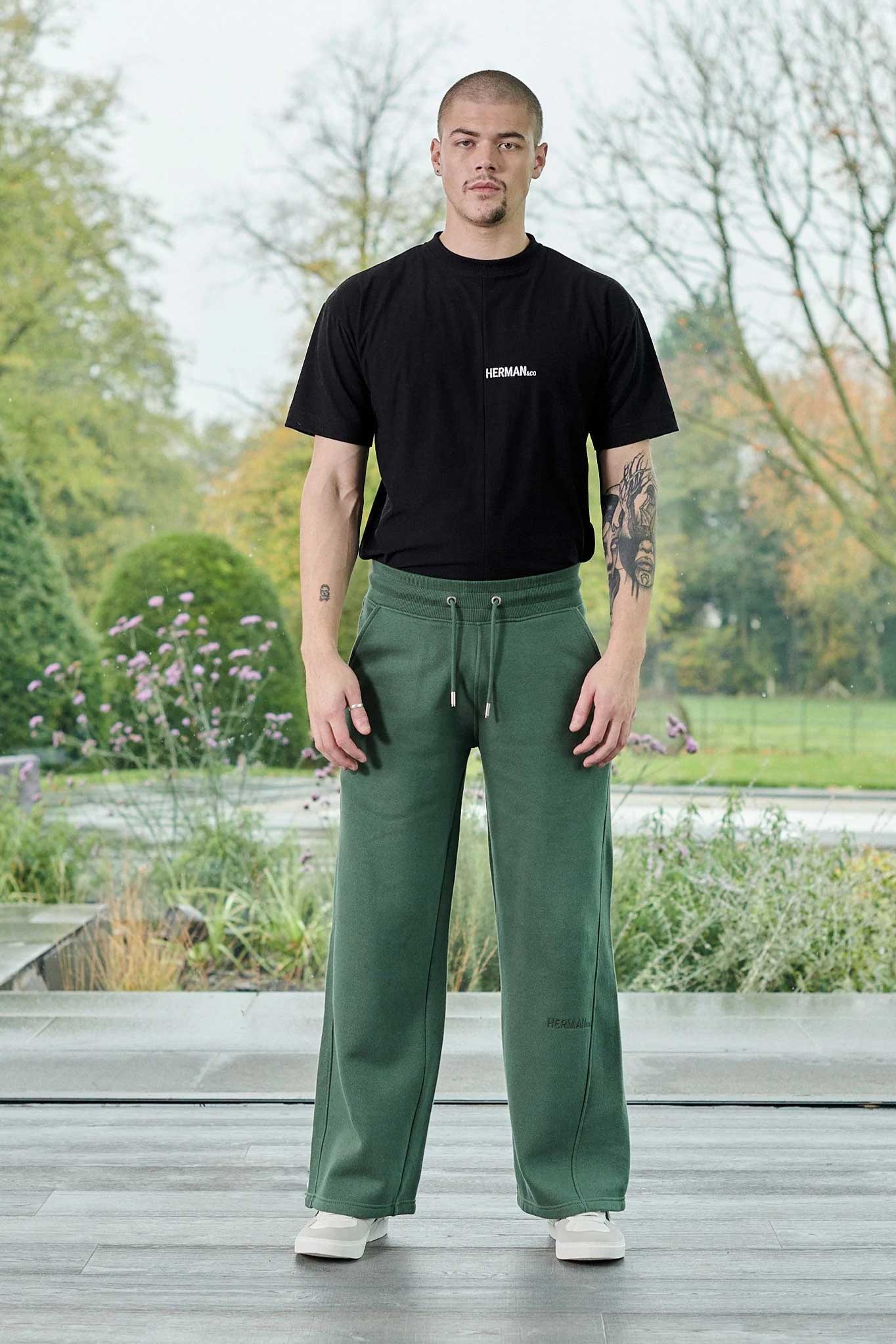 Front view of a model styled in the green joggers for men