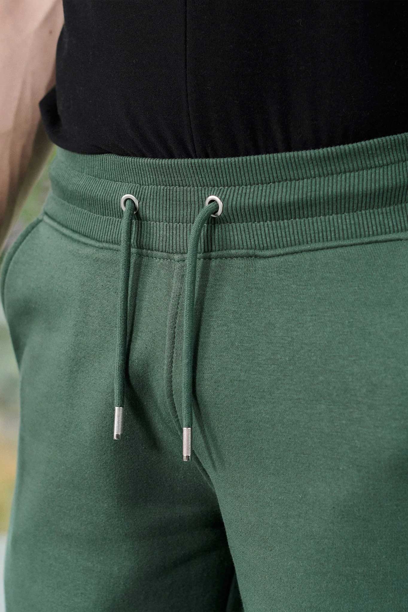 Close-up of the drawstring waist on the men's green wide-leg joggers.