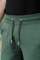 Close-up of the drawstring waist on the men's green wide-leg joggers.