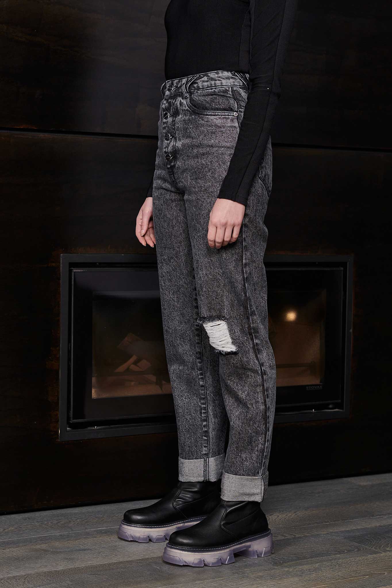 Side profile of a model wearing grey wash mom jeans to show the straight leg cut