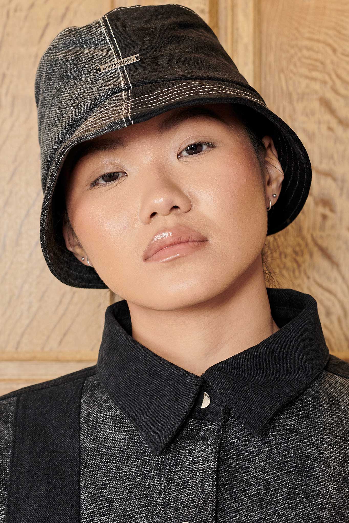 Front view of a model wearing the Herman & Co acid wash bucket hat