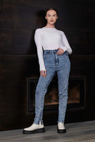 A model posing in the high-waisted acid wash skinny jeans