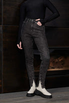 Showcasing the fit of the high-waisted black acid wash skinny jeans