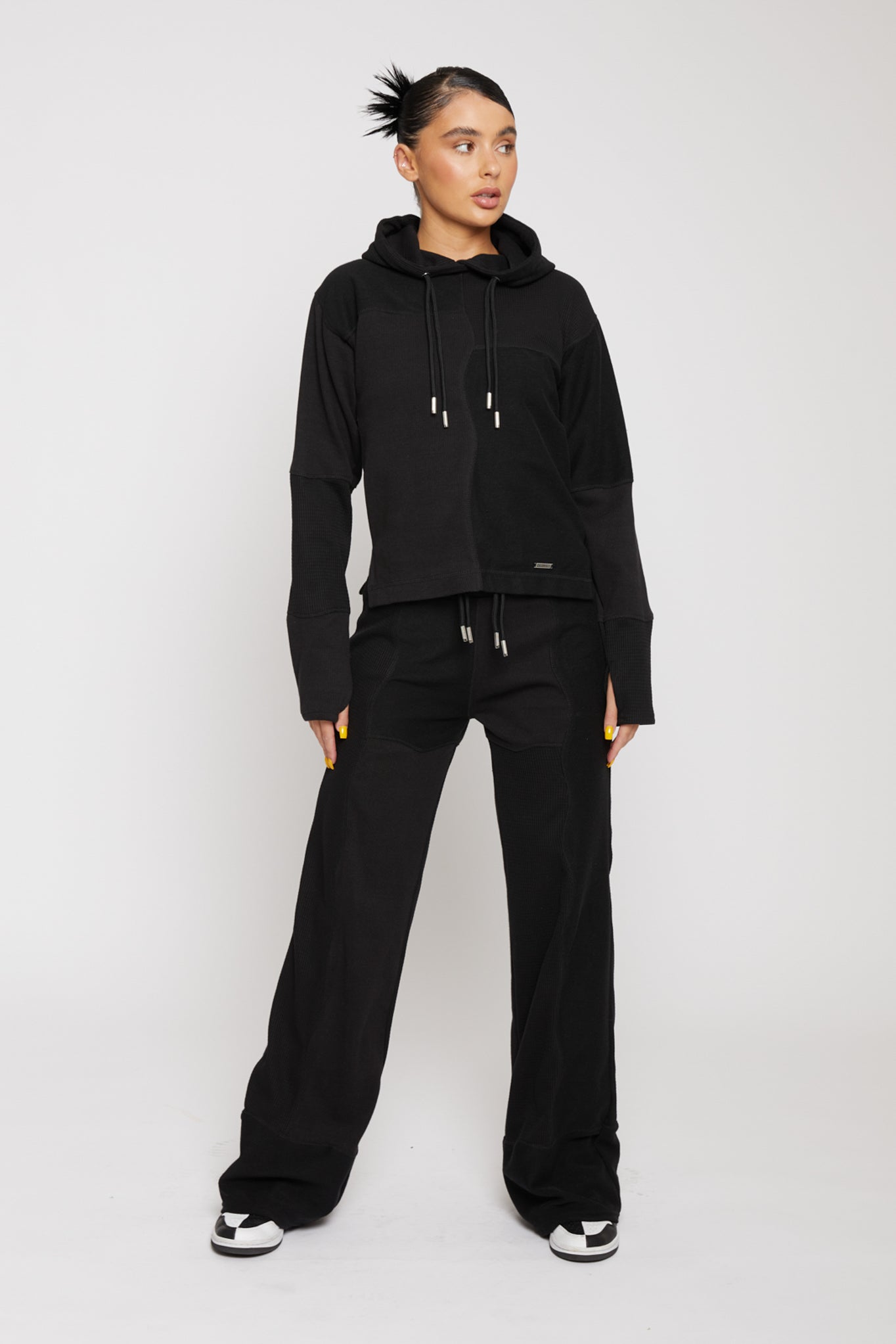 Rear view of model showing the waistband and fit of black kroen joggers