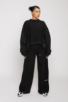 Front view of model wearing ladies wide leg jogger black with a relaxed fit
