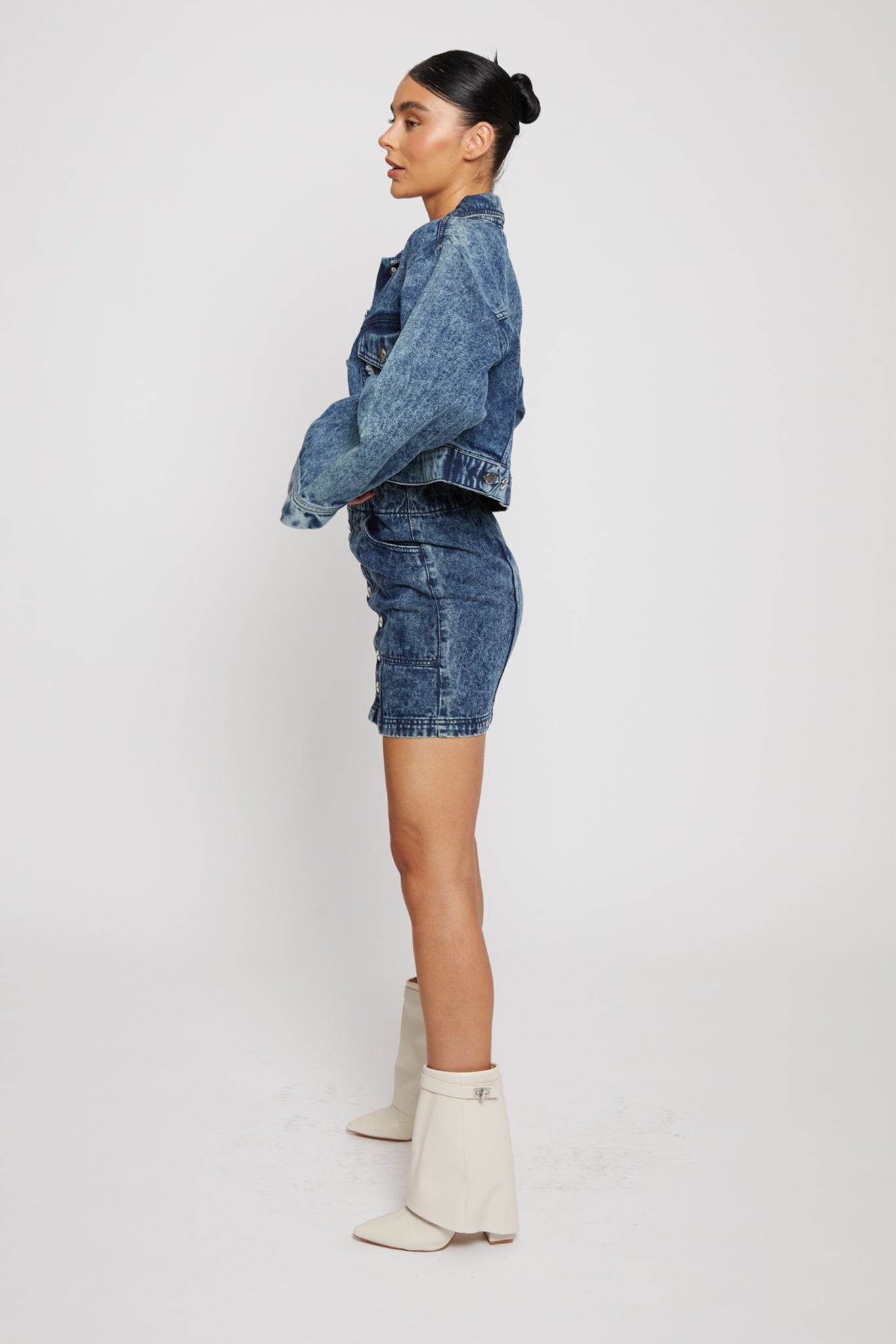 Side profile of a model wearing the light wash cropped denim jacket.
