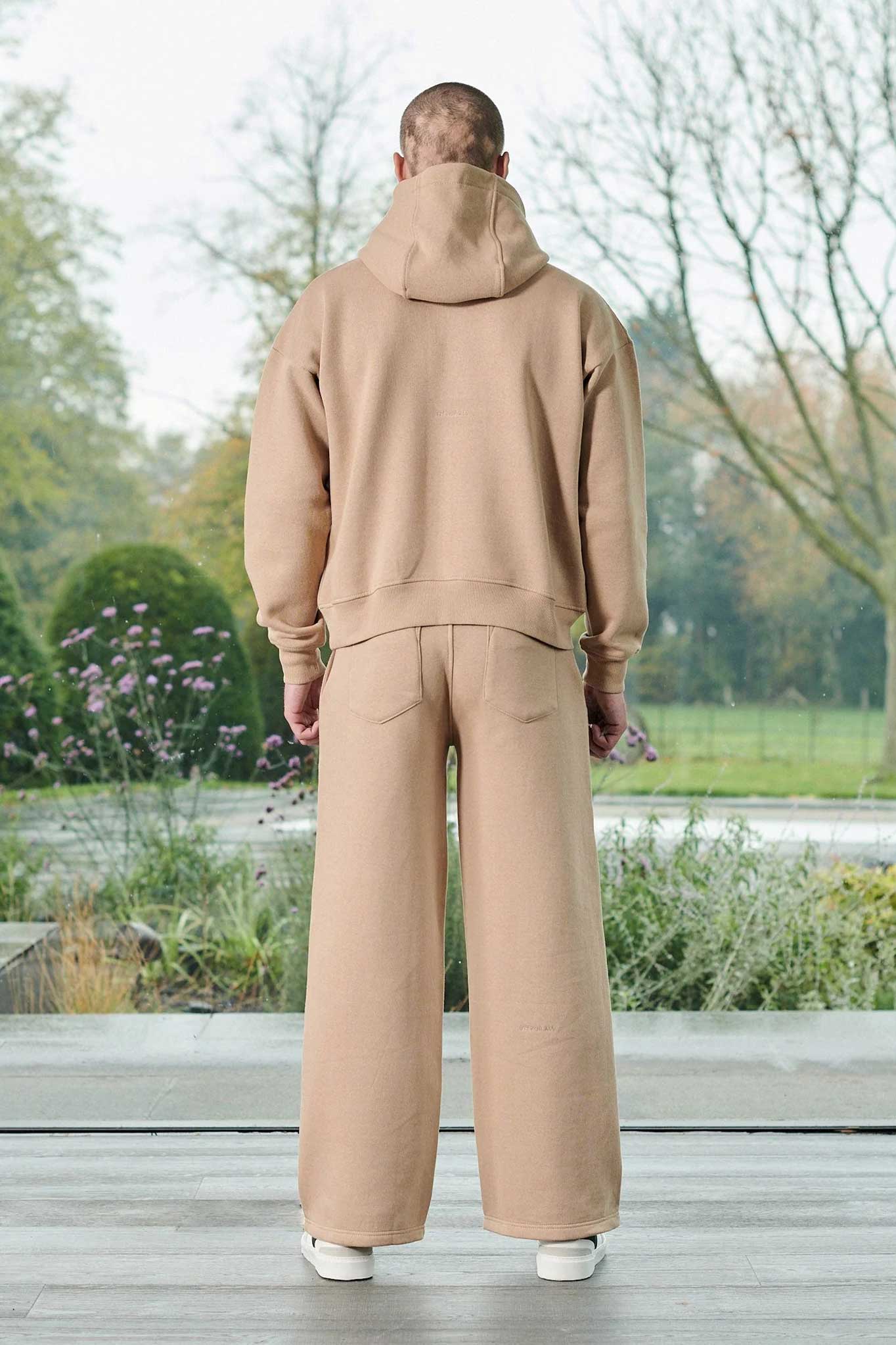 Back view of a model in the men's beige wide-leg joggers