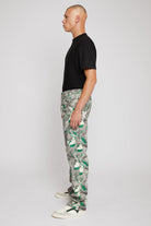 Side profile of a model showing the fit of the men's printed jeans.