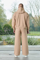 Model posing in a casual beige pullover hoodie men outfit essential look
