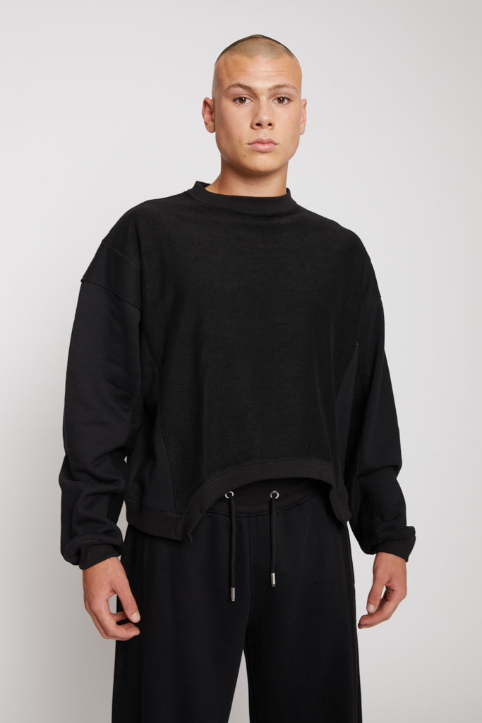 Close-up of the men's black crew neck jumper showing the fabric and fit.