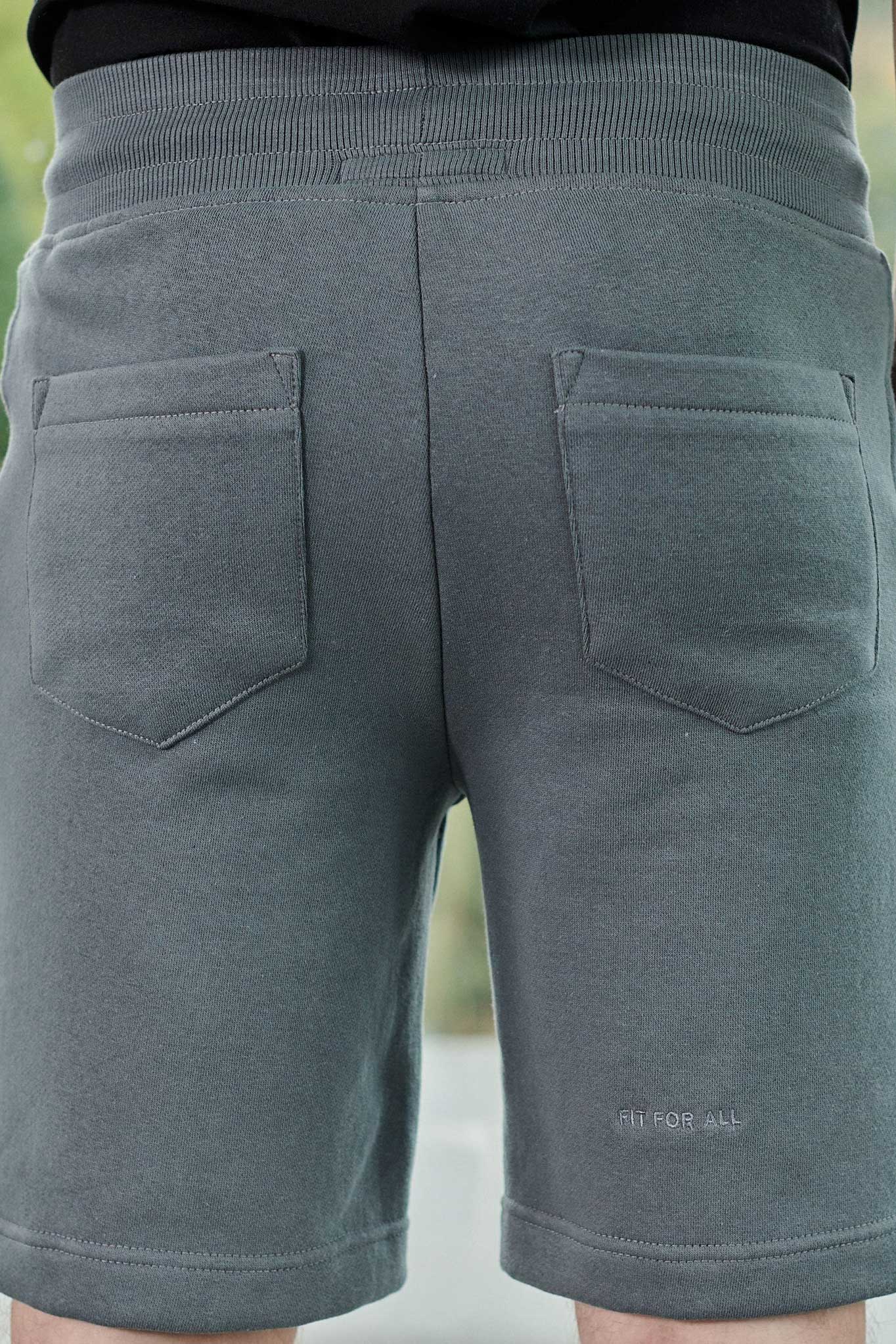 Rear view showing the back pocket detail on grey tech shorts for men