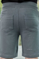 Rear view showing the back pocket detail on grey tech shorts for men