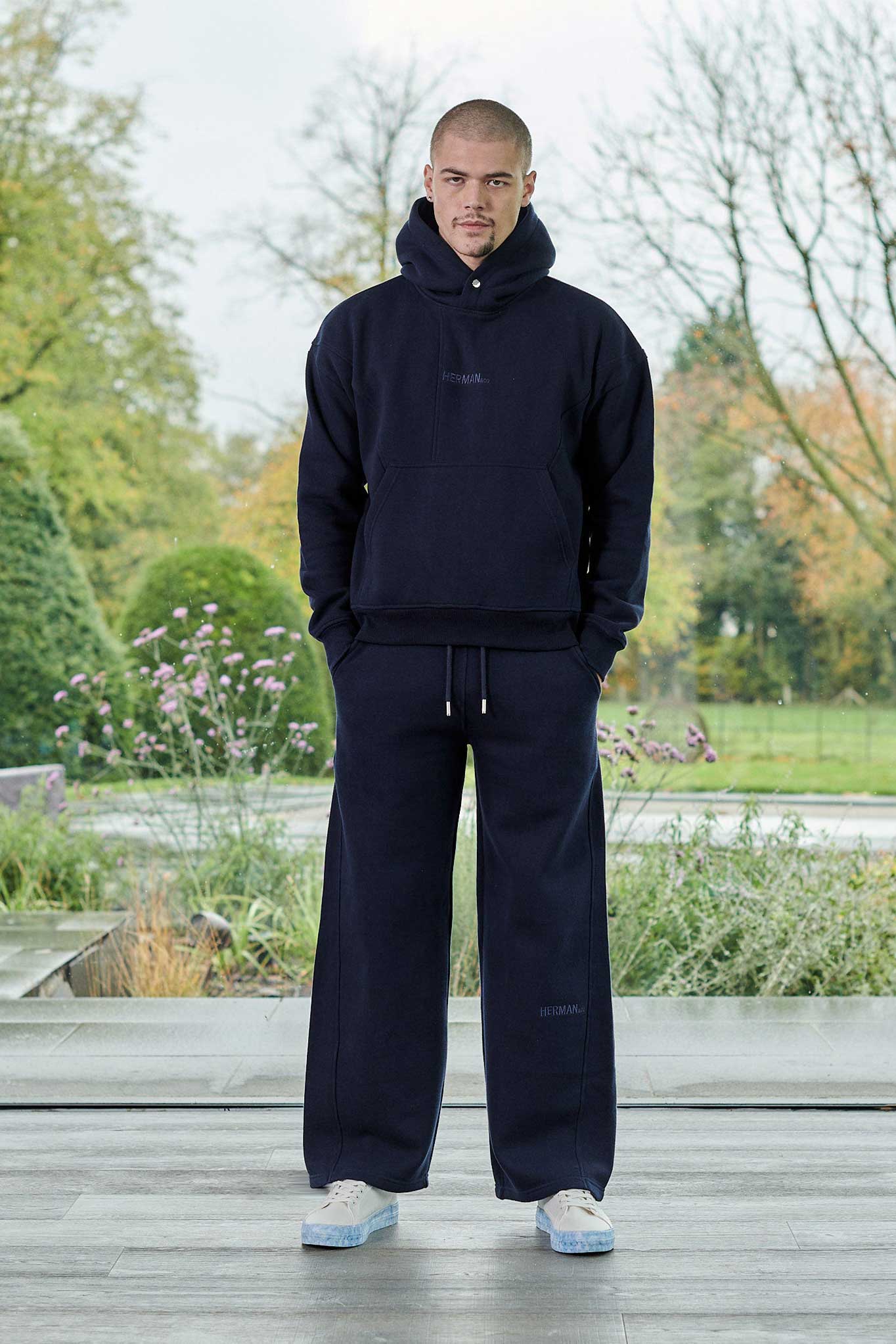 Front view of model wearing mens dark navy hoodie with matching joggers