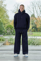 Front view of model wearing mens dark navy hoodie with matching joggers