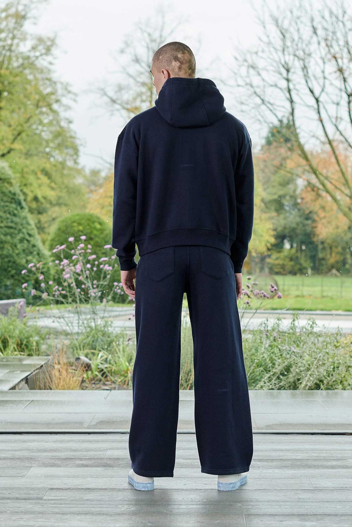 Side profile view displaying the drop shoulder fit of the dark navy hoodie