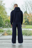 Side profile view displaying the drop shoulder fit of the dark navy hoodie