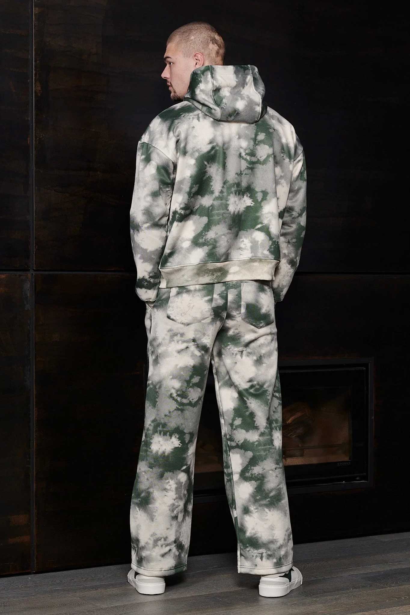 Rear view of relaxed fit mens green tie dye hoodie and joggers set