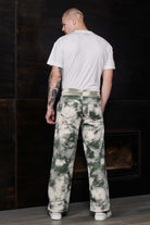 Back view of a model wearing the men's green tie-dye joggers.
