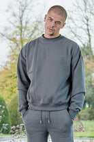 Front view of model wearing mens grey crew neck jumper in cool grey