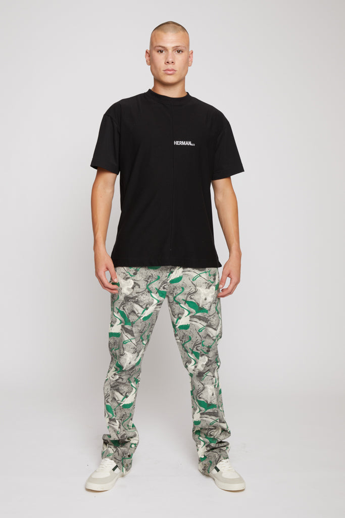 Front view of a model wearing the men's printed denim jeans.