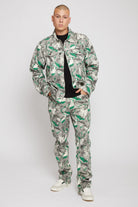 A model wearing the men's psychedelic print jacket with matching jeans.