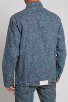 Back view of the men's speckled jacket showing the logo patch detail