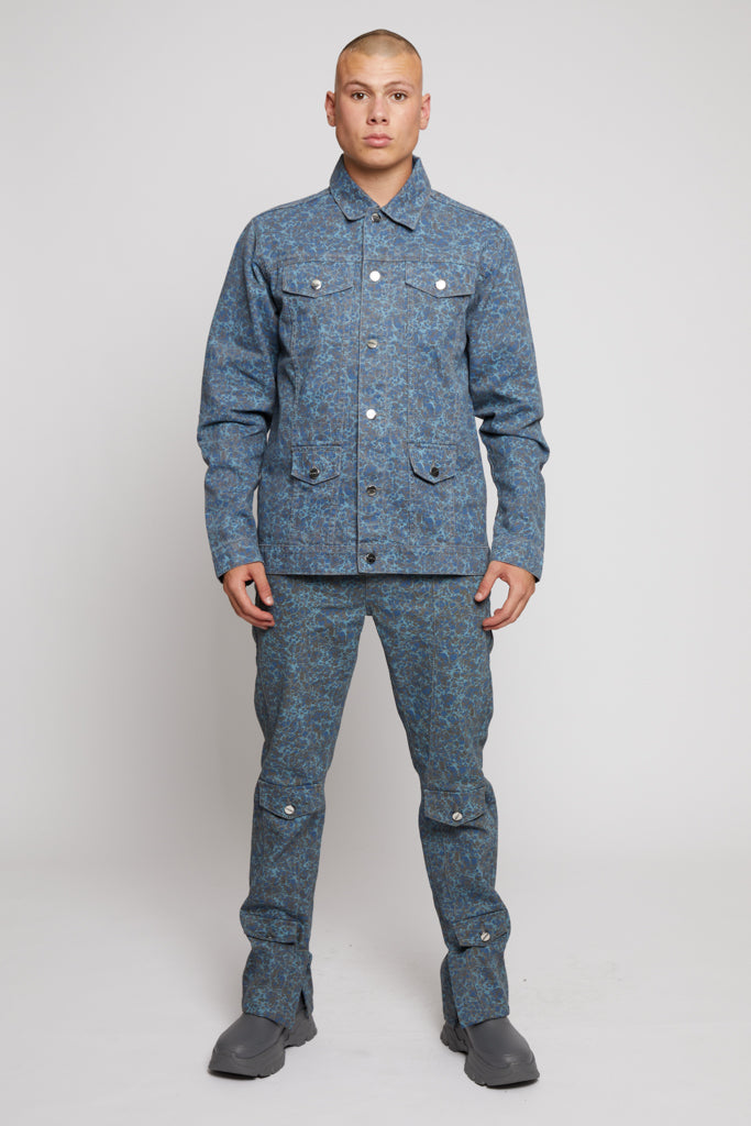 A model styled in the complete men's speckled print denim outfit.