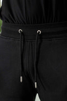 Close-up of the drawstring waistband on the men's tapered joggers