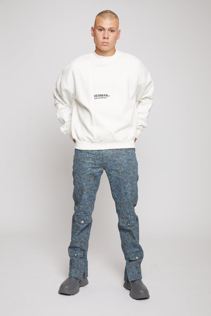 Full view of model wearing white fleece crewneck sweatshirt mens with black chest logo