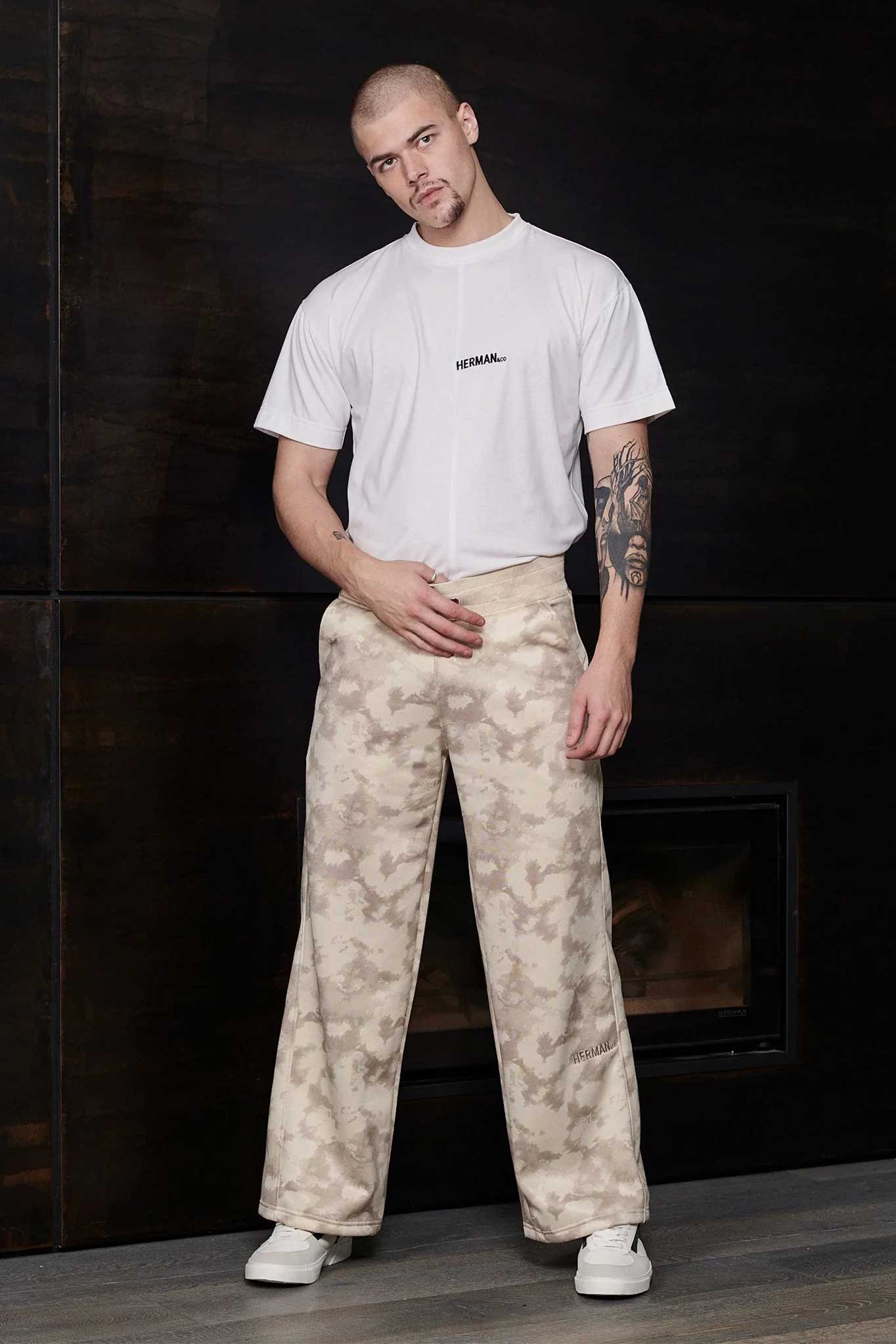 Front view of model wearing beige wide leg joggers with a white t-shirt