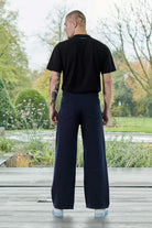 Back view of a model wearing the navy joggers for men.