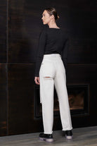 Back view of a model in the off-white distressed jeans for women.