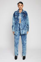 A model styled in the oversized bleach wash shirt for women.