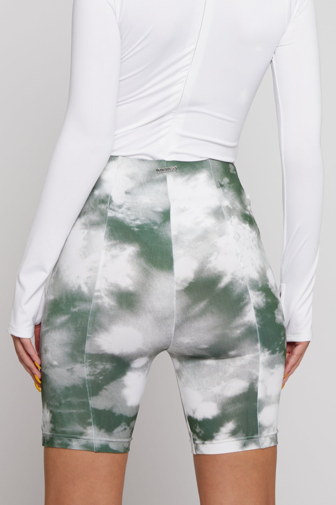 Back view of the women&#39;s printed cycling shorts in green and white.