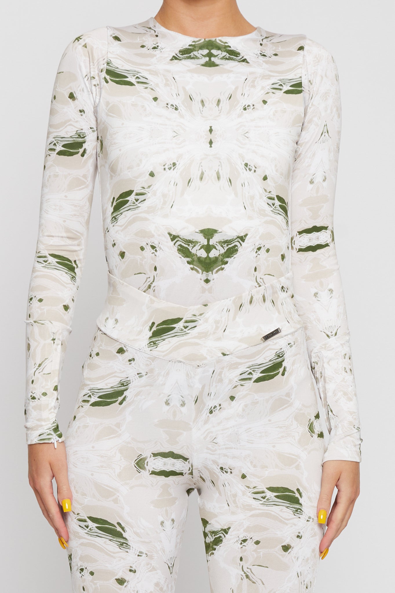 Close-up view of the printed dipped leggings and matching long-sleeve top.