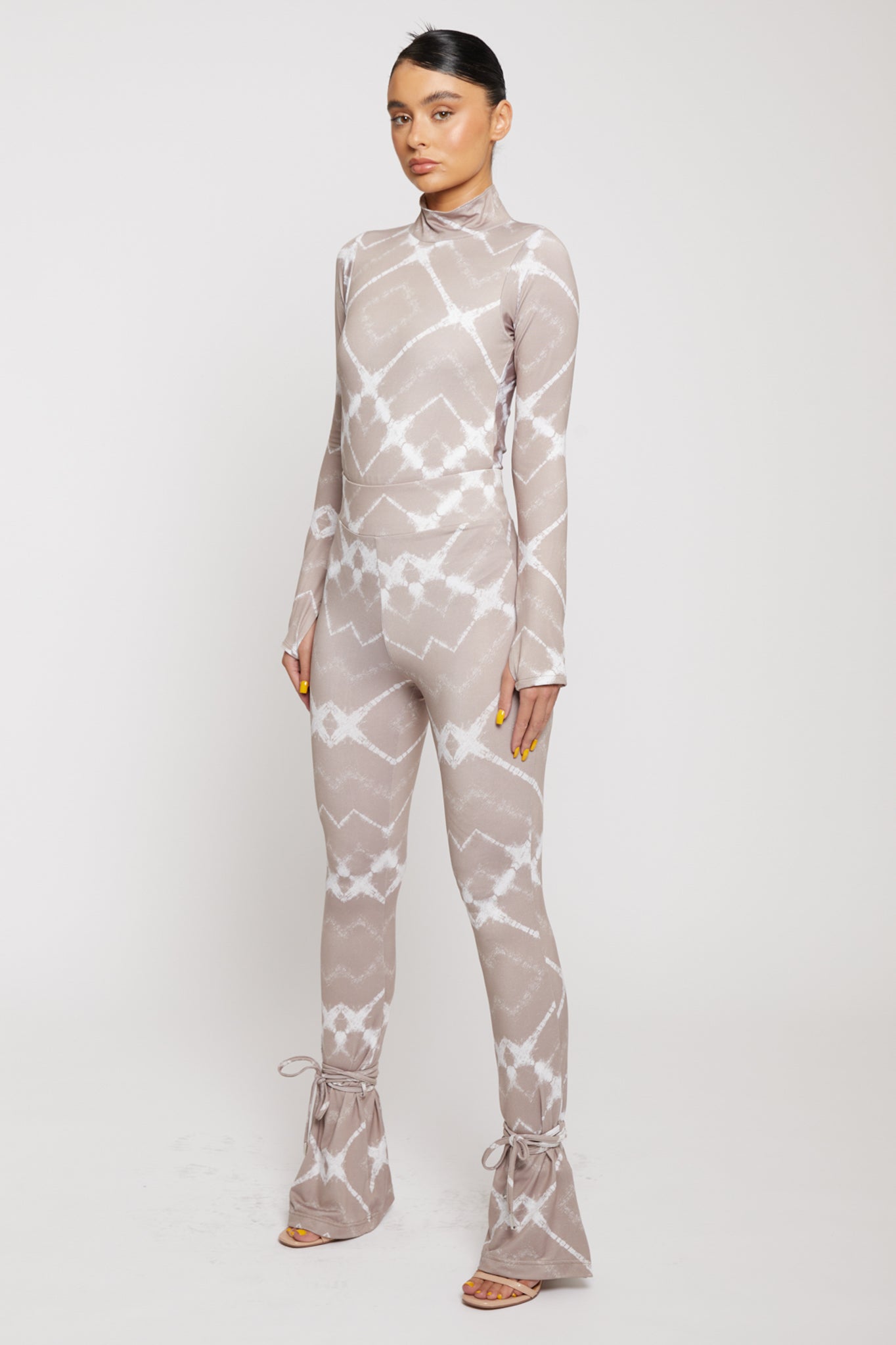 Angled front view of a model in the printed flare leggings.