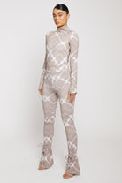 Angled front view of a model in the printed flare leggings.