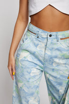 Close-up of the unique cut-out detail on the hip of the psychedelic jeans.