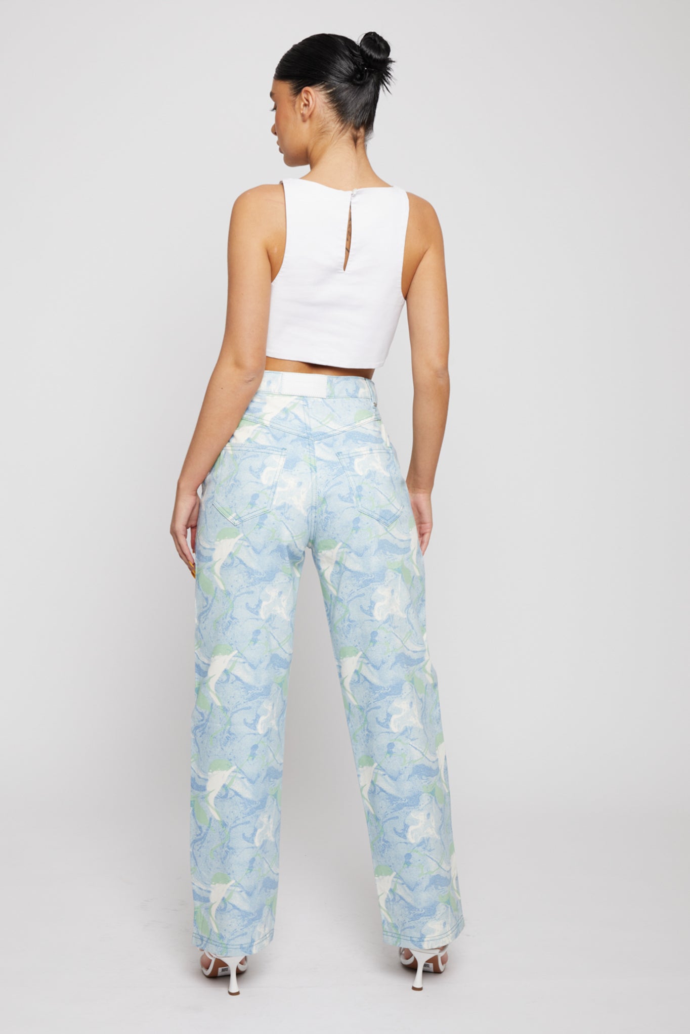 Back view of a model wearing the women's psychedelic jeans.