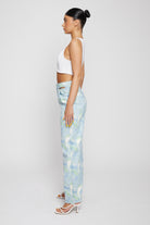 Side profile of a model showing the fit of the psychedelic straight-leg jeans.