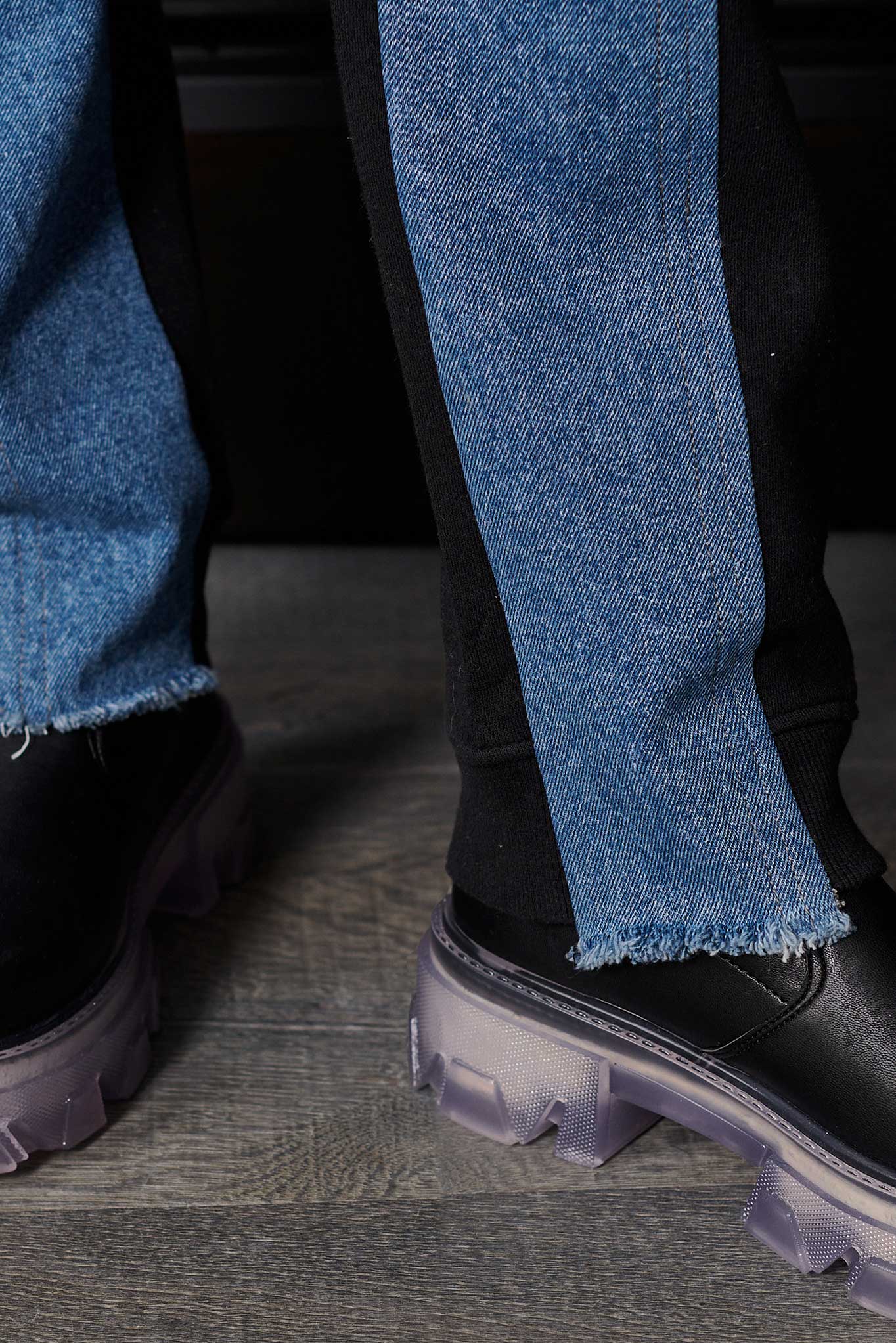 Close-up of the frayed denim hem on the straight leg denim joggers
