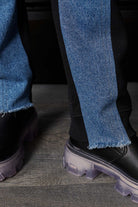 Close-up of the frayed denim hem on the straight leg denim joggers