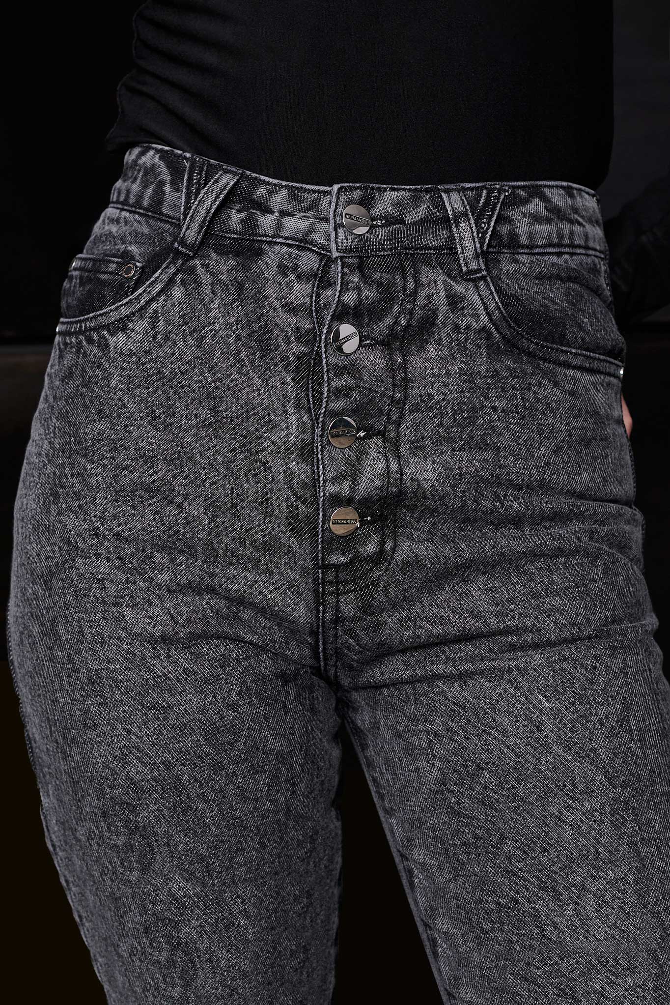 A model styling the grey distressed mom jeans for a complete streetwear look