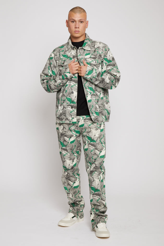 A model styled in the men's psychedelic jacket, worn open with a black t-shirt.