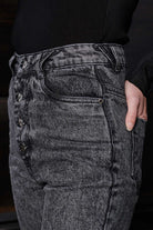 Close-up on the super distressed ripped detail on the grey mom jeans